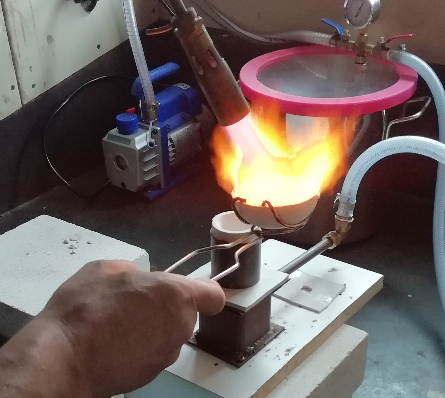 man pouring silver in a mould